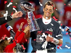 Buccaneers quarterback Tom Brady celebrates with the Vince Lombardi Trophy after beating the Chiefs in Super Bowl LV at Raymond James Stadium in Tampa, Fla., Feb 7, 2021.