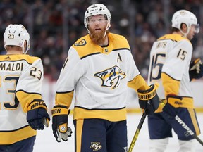 Ryan Ellis, centre, of the Nashville Predators celebrates with Rocco Grimaldi, left, and Craig Smith after scoring a goal against the Colorado Avalanche in the third period at the  Pepsi Center on Nov. 7, 2019 in Denver.