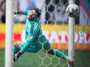 Toronto FC goalkeeper Alex Bono allows a goal to Vancouver Whitecaps' Brian White during the first half of the Canadian Championship soccer final, in Vancouver, on Tuesday, July 26, 2022.
