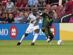 Toronto FC defender Chris Mavinga (23) battles for the ball against Portland Timbers forward Yimmi Chará (23) during first half MLS Soccer action in Toronto on Aug. 13, 2022.