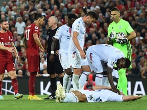 Liverpool v Crystal Palace - Anfield, Liverpool, Britain - August 15, 2022
Crystal Palace's Joachim Andersen is on the floor after sustaining an injury as Liverpool's Darwin Nunez is sent off by referee Paul Tierney.
