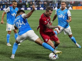 Aug 27, 2022; Charlotte, North Carolina, USA; Charlotte FC defender Jaylin Lindsey (24) tries for a steal from Toronto FC Frederico Bernardeschi (10) during the second half at Bank of America Stadium.