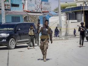 Security forces patrol at the scene after gunmen stormed a hotel in Mogadishu, Somalia Sunday, Aug. 21, 2022.