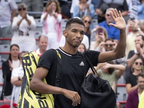 Canada's Felix Auger-Aliassime walks off the court after losing to Casper Ruud of Norway for his win in quarterfinal play at the National Bank Open tennis tournament, Friday, August 12, 2022 in Montreal.