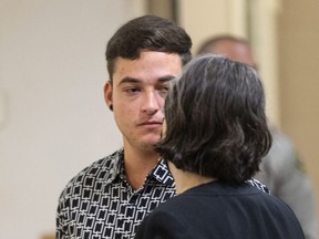 Evan Frostick talks to his public defender after he was taken into custody and charged with murder and child cruelty in Sonoma County Superior Court in Santa Rosa, Calif., Thursday, Aug. 4, 2022.
