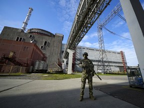 A Russian soldier stands guard in an area of ​​the Zaporizhzhia nuclear power plant in territory under Russian military control, in southeastern Ukraine, May 1, 2022.
