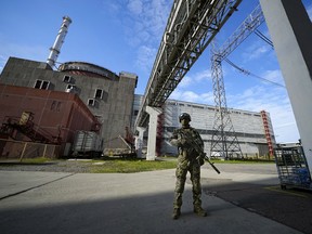 A Russian soldier stands guard in an area of the Zaporizhzhia nuclear power plant in territory under Russian military control, in southeastern Ukraine, May 1, 2022.