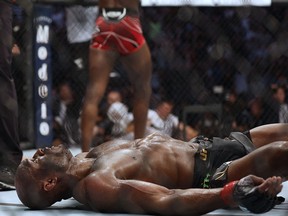 Kamaru Usman lays in the ring after being knocked out by Leon Edwards during UFC 278 at Vivint Arena.