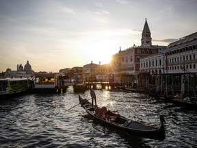 In this file photo taken on September 14, 2019 a gondola sails at sunset on the Grand Canal in front of the Palazzo Ducale - Doge's Palace in Venice.