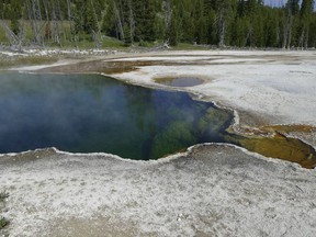 In this photo provided by the National Park Service is the Abyss Pool hot spring in the southern part of Yellowstone National Park, Wy., in June 2015.
