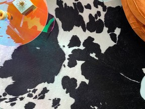 A faux hide rugs works on its own or layered over another rug.