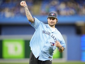 Auston Matthews of the Toronto Maple Leafs throws out the ceremonial first pitch before the game between the New York Yankees and the Toronto Blue Jays in their MLB game at the Rogers Centre on Sept. 27, 2022.