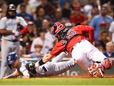 Cavan Biggio of the Toronto Blue Jays scores the game winning run in the tenth inning against the Boston Red Sox at Fenway Park on August 25, 2022 in Boston, Massachusetts.