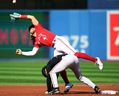 Bo Bichette of the Toronto Blue Jays avoids Terrin Vavra of the Baltimore Orioles to make a catch.