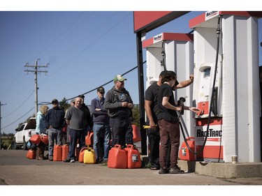 Local residents wait in line to fill up gas cans a day after Post-Tropical Storm Fiona hit the Atlantic coast on Sept. 25, 2022 in New London, Prince Edward Island.