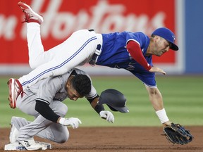 Oswald Peraza #91 of the New York Yankees collides with Whit Merrifield #1 of the Toronto Blue Jays at second base as Merrifield tries to complete the double play at first in the first inning of the game at Rogers Centre on September 28, 2022 in Toronto, Canada.