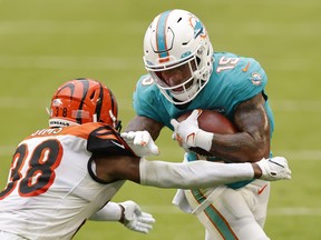 Wide receiver Lynn Bowden Jr. #15 of the Miami Dolphins runs with the ball against cornerback LeShaun Sims #38 of the Cincinnati Bengals in the third quarter of the game at Hard Rock Stadium on December 06, 2020 in Miami Gardens, Florida.