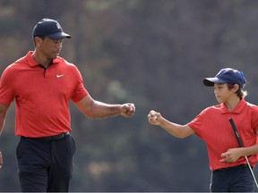 Tiger Woods and Charlie Woods celebrate a birdie on the 13th hole during the final round of the PNC Championship at the Ritz Carlton Golf Club Grande Lakes on December 19, 2021 in Orlando, Florida.