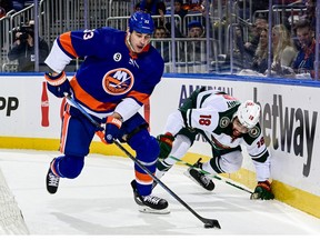 Zdeno Chara of the New York Islanders is pursued by Jordan Greenway of the Minnesota Wild during the first period at UBS Arena on January 30, 2022 in Elmont, New York.
