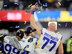 Andrew Whitworth #77 of the Los Angeles Rams raises the Vince Lombardi Trophy following Super Bowl LVI at SoFi Stadium on February 13, 2022 in Inglewood, California.