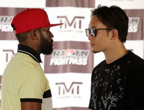Boxer Floyd Mayweather Jr., left, and mixed martial artist Mikuru Asakura face off during a news conference announcing their exhibition boxing bout at The M Resort on June 13, 2022 in Henderson, Nevada.