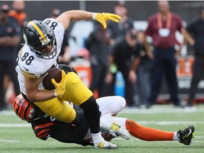 Pat Freiermuth of the Pittsburgh Steelers is tackled during the game against the Cincinnati Bengals at Paul Brown Stadium on September 11, 2022 in Cincinnati, Ohio.
