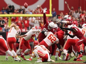 Place kicker Harrison Butker of the Kansas City Chiefs kicks a 54-yard field goal over defensive tackle Leki Fotu of the Arizona Cardinals during the first half of the NFL game at State Farm Stadium on September 11, 2022 in Glendale, Arizona.