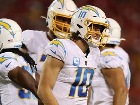 Justin Herbert #10 of the Los Angeles Chargers reacts in pain after a play during the fourth quarter against the Kansas City Chiefs at Arrowhead Stadium on September 15, 2022 in Kansas City, Missouri. (Photo by Jamie Squire/Getty Images)