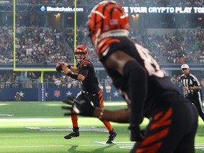 Bengals quraterback Joe Burrow passes the ball to receiver Tee Higgins for a touchdown against the Dallas Cowboys on Sunday. The Bengals, who are now 0-2, made it all the way to the Super Bowl last season.