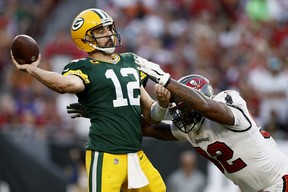 Aaron Rodgers of the Green Bay Packers calmly throws a pass with pressure from William Gholston of the Tampa Bay Buccaneers during the fourth quarter in the game at Raymond James Stadium on September 25, 2022 in Tampa, Florida. (Douglas P. DeFelice/Getty Images)