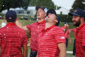 Jordan Spieth, Sam Burns and Cameron Young of the United States Team celebrate after defeating the International Team during Sunday singles matches on day four of the 2022 Presidents Cup at Quail Hollow Country Club on September 25, 2022 in Charlotte, North Carolina. (Photo by Rob Carr/Getty Images)