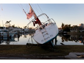 A sailboat which was pushed ashore by Hurricane Ian sits on dry ground on Sept. 30, 2022 in Fort Myers, Fla.