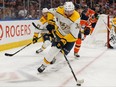 Edmonton Oilers' Kailer Yamamoto (56) chases Nashville Predators' Yakov Trenin (32) during third period NHL hockey action at Rogers Place in Edmonton, on Tuesday, Jan. 14, 2020.