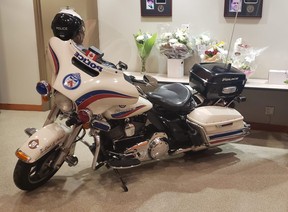 Const. Andrew Hong’s motorcycle is pictured in the lobby of Traffic Services along with flowers on Tuesday, Sept. 13, 2022.