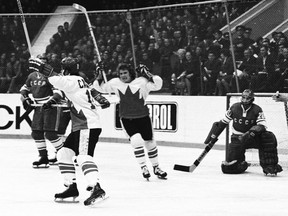 MOSCOW - SEPTEMBER 28, 1972: Paul Henderson #19 (with helmet) and Bobby Clarke #28 of Team Canada celebrate Henderson's series-winning goal in Game 8 of the 1972 Summit Series between Canada and the Soviet Union at the Luzhniki Ice Palace in Moscow, Soviet Union on September 28, 1972.