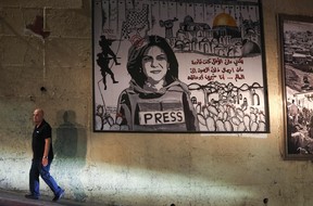 A man walks past a mural depicting slain Palestinian-American journalist Shireen Abu Akleh, on a street in the Arab town of Umm Al-Fahm in northern Israel, on Sept. 5, 2022.