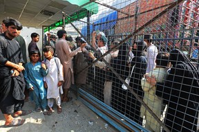 Afghan people prepare to cross over to Pakistan through the Afghanistan-Pakistan joint border crossing in Torkham of Nangarhar province on Sept. 15, 2022.