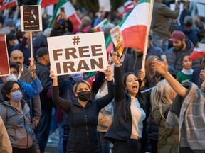 People demonstrate against the Iranian regime during a protest at Mel Lastman Square in on Sept. 24, 2022. Iran has been rocked by street violence since the death last week of Mahsa Amini, a 22-year-old Kurd who had spent three days in a coma after being detained by the morality police.