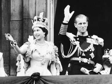 (FILES) In this file photo taken on June 2, 1953 Britain's Queen Elizabeth II (L) accompanied by Britain's Prince Philip, Duke of Edinburgh (R) waves to the crowd, June 2, 1953 after being crowned at Westminter Abbey in London. - Queen Elizabeth II's 99-year-old husband Prince Philip, who was recently hospitalised and underwent a successful heart procedure, died on April 9, 2021, Buckingham Palace announced. (Photo by - / INTERCONTINENTALE / AFP) (Photo by -/INTERCONTINENTALE/AFP via Getty Images)