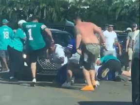A Josh Allen fan is attacked by a Miami Dolphins fan in a viral video.