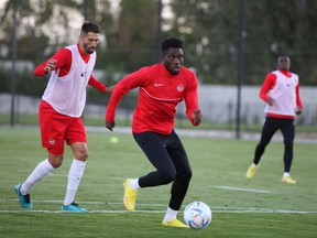 Canadian forward Alphonso Davies controls the ball with defender Steven Vitoria chasing him at the MOL Football Academy in Dunajská Streda, Slovakia on Sept. 20, 2022.