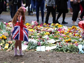 Six year old Ann Doran stands near floral tributes left at Green Park, following the death of Britain's Queen Elizabeth, in London September 15, 2022.