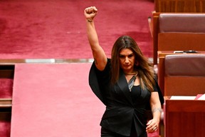Indigenous Australian parliamentarian Lidia Thorpe raises her fist during her swearing-in ceremony in the Senate chamber at Parliament House in Canberra, Australia, Aug. 1, 2022.