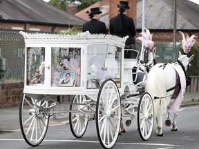 A picture of nine-year-old Olivia Pratt-Korbel is seen with her coffin on a horse-drawn carriage during her funeral after she was shot and killed at her home, in Liverpool, Britain, September 15, 2022.
