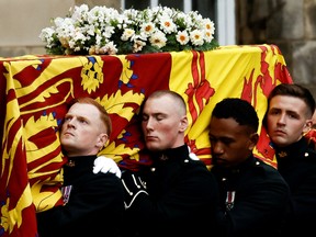 Pallbearers carry the coffin of Queen Elizabeth as the hearse arrives at the Palace of Holyroodhouse in Edinburgh, Scotland September 11, 2022.