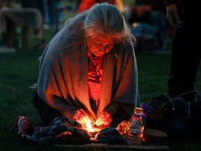 A woman prepares for sunrise ceremony, attended by Prime Minister Justin Trudeau to mark the National Day for Truth and Reconciliation, honouring the lost children and survivors of Indigenous residential schools, at Niagara Parks power station in Niagara Falls, Ont., Sept. 30, 2022.