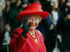 Queen Elizabeth II waves as she leaves the Royal York Hotel in Toronto Friday October 11, 2002. The Queen left for New Brunswick where she will continue her twelve-day Golden Jubilee tour of Canada. (CP PHOTO/Kevin Frayer)