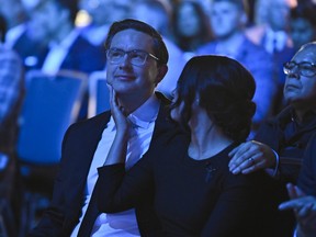 Anaida Poilievre, wife of Conservative Party leadership candidate Pierre Poilievre, touches his chin as they listen to speeches at the Conservative Party of Canada leadership vote, in Ottawa, on Saturday, Sept. 10, 2022.