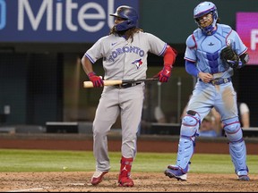 Blue Jays' Vladimir Guerrero Jr., left, and Texas Rangers catcher Jonah Heim react after the final strike ending the baseball game in Arlington, Texas, on Sunday, Sept. 11, 2022.