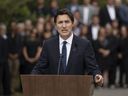 Prime Minister Justin Trudeau, makes a speech as Liberal MPs looks on, during the Liberal summer caucus retreat in St. Andrews, N.B. on Monday, September 12, 2022. 